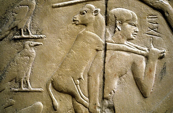 Detail of a relief depicting a man carrying a sacrificial animal (stone)