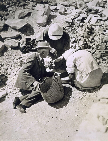 Sir Charles Cust (in soft hat) the Kings Equerry, with Mr Callender sifting the dust from the floor of the Tomb of Tutankhamun, Valley of the Kings, 1922 (gelatin silver print)