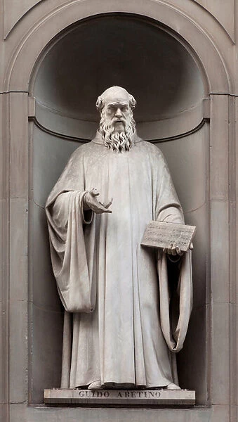 Statue of Guido d Arezzo or Guy d Arezzo (Guido Aretinus, Guido Monaco), (992-1050), Benedictine monk, Italian musician, known for writing the musical notation on the scope, Sculpture by Lorenzo Nencini (1806-1847)