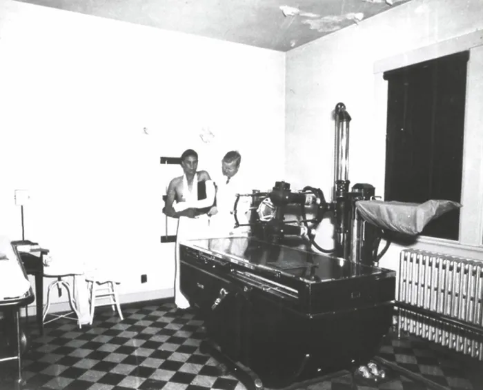 Framed Print : A technician preparing an x-ray Framed Print : A technician preparing an x-ray