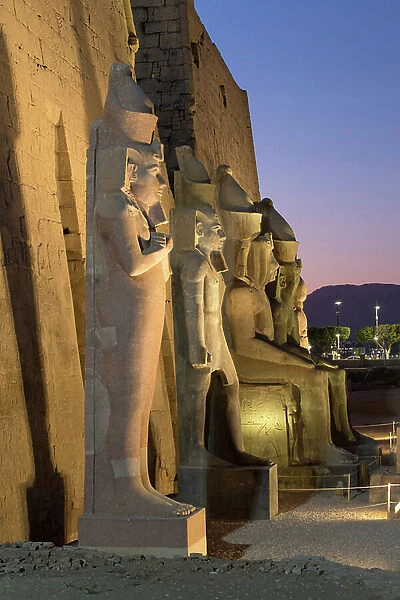 Temple of Luxor at dusk with colossal statues of Ramses ll, Luxor, Egypt
