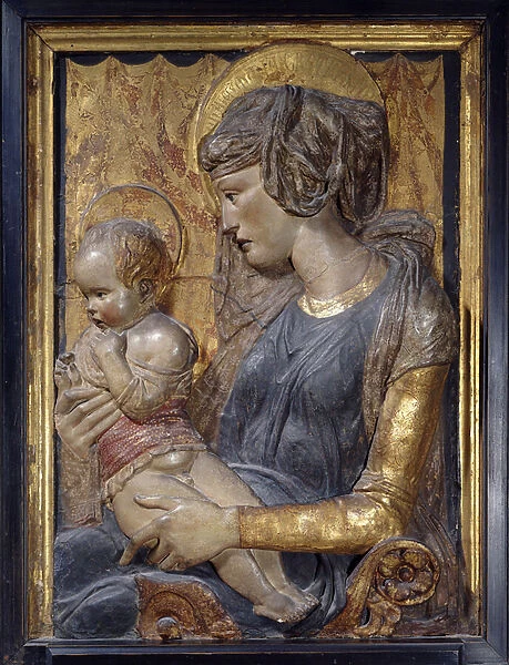 Virgin and child. Terracotta relief painted and doree by Donatello (1386 - 1466), 1440