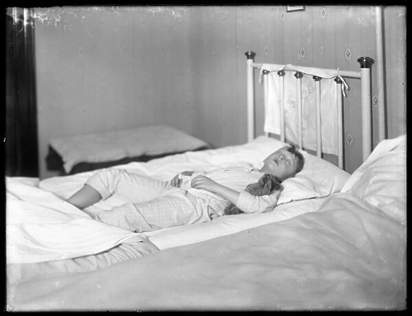 William Gray Hassler asleep with his teddy bear, c. 1913 (b  /  w photo)