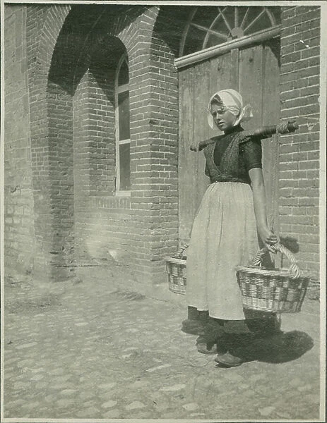 Woman with two baskets, Photograph from Travels in Europe and North Africa, 1910 (b / w photo)