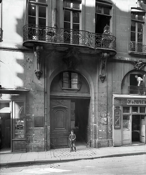 Young boy before no 52, rue Saint-Andre-des-Arts, 1920 (b  /  w photo)