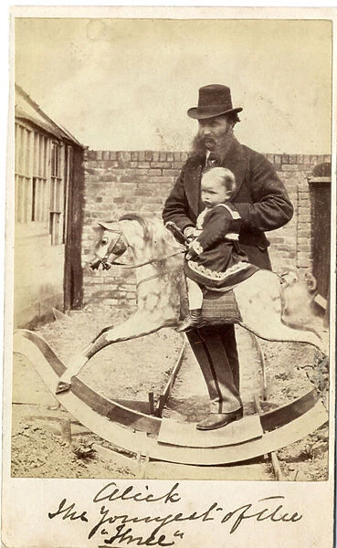 Young girl on a rocking horse in the garden, her father beside, 1860s (albumen print)