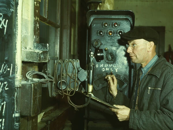 Hump master in a Chicago and North Western railroad yard operating a signal... Chicago, Ill. 1942. Creator: Jack Delano