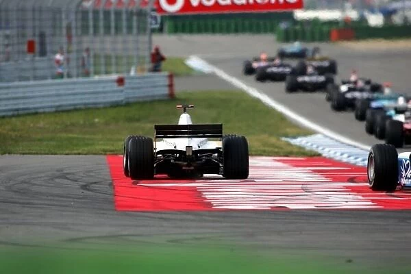 GP2. The cars run wide at the start of the race at the hairpin.