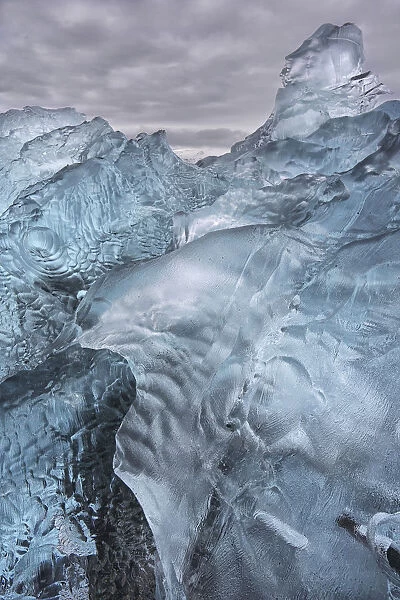 A close-up view of glacial ice strewn across a coastal beach; iceland