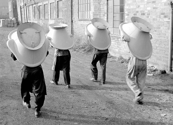 An alternative use for a hip bath. These workmen are using them as a hats during their