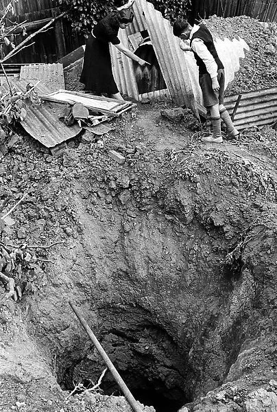 Bomb crater beside a garden shelter after an air raid on London 1940 WW2