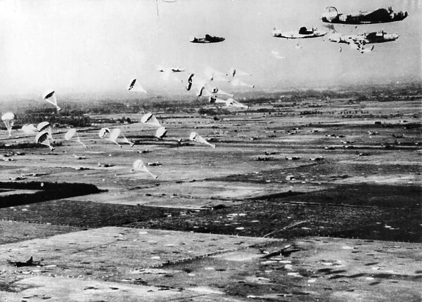 A flight of B24 Liberators swoops in low over the Dutch countryside to drop supplies to