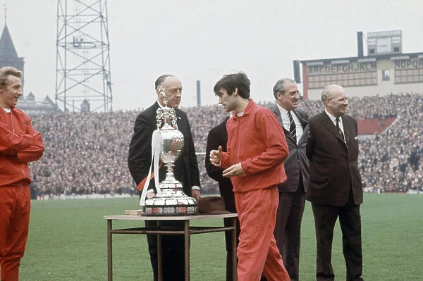 Manchester United footballer George Best picks up his medal during the League