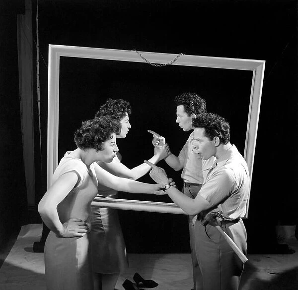 Mirror image: A couple argue in front of a mirror. 1958