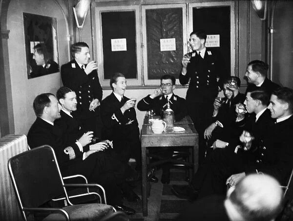 Officers of HMS Ajax and Exeter enjoying a drink during the interval at the London