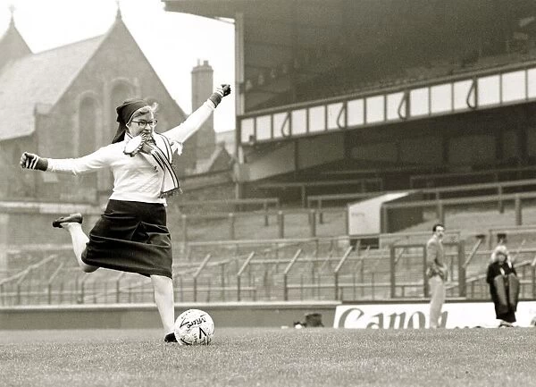 Soccer Sister - Nun kicking football shooting at goal Goodison Park Everton