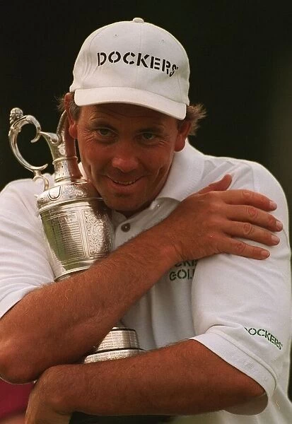 Tom Lehman hugs Claret jug trophy after winning British Open golf championship at Lytham
