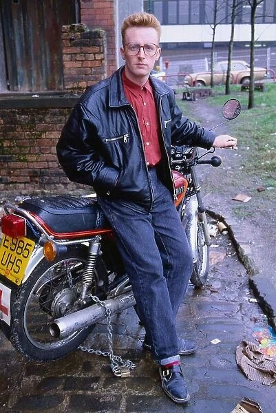 TV presenter Bryan Burnett sitting on motorcycle 1990
