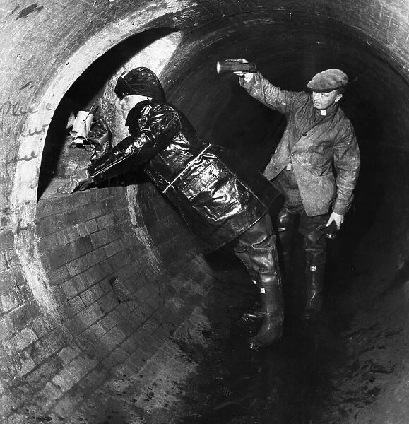 Workmen inspect the underground sewer tunnel that extends from under the Mersey tunnel