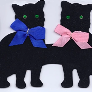 Two black cats made of felt