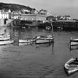 Boats in the harbour at Mousehole, Cornwall, England. Date: 1950s