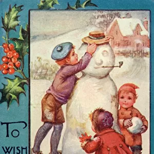 Three children completing their snowman