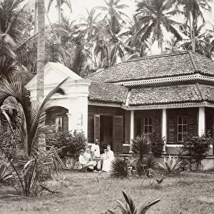 European family outside their colonial bungalow