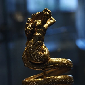 Gold armband with female triton holding a small winged Eros