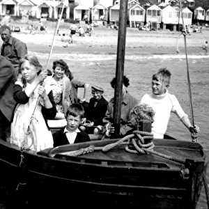 Holidaymakers enjoying a boat ride, Walton, Essex