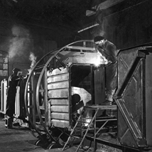 Metalworkers welding a railway carriage