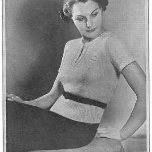 Model wearing a short-sleeved knitted spring jumper Date: 1936