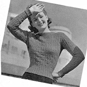Model wearing tight knitted sweater in fancy rib stitch. Date: 1940
