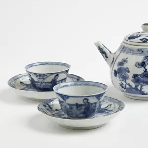 Teapot with two cups and saucers