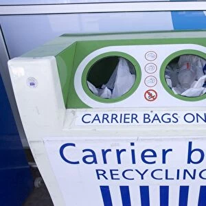 Carrier bag recycling container outside Tesco food store for disposing of plastic bags. Tesco does not charge customers for plastic carrier bags but has recently changed to using biodegrradable plastic