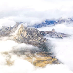 Aerial view by drone of Ra Gusela and Cinque Torri mountains covered by clouds