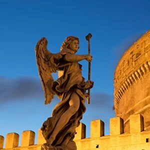Angel statue on Ponte Sant Angelo bridge at dusk with Castel Sant Angelo, Rome, Lazio, Italy, Europe