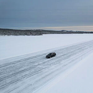 Car on icy road on a frozen lake from above, aerial view, Lapland, Sweden, Scandinavia, Europe