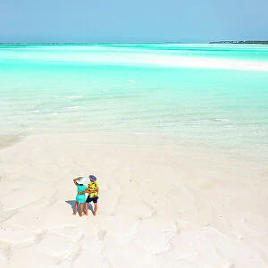 Cheerful man and woman embracing on idyllic tropical beach, overhead view, Nungwi, Zanzibar, Tanzania, East Africa, Africa