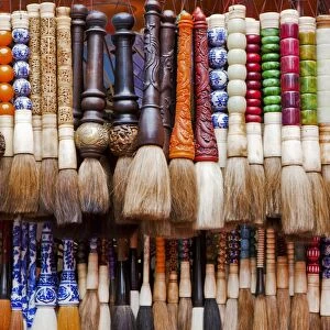 Chinese calligraphy brushes with colorful handcarved handles of stone and wood