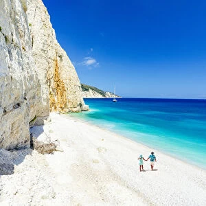 Man and woman holding hands on the idyllic Fteri Beach, overhead view, Kefalonia, Ionian Islands, Greek Islands, Greece, Europe