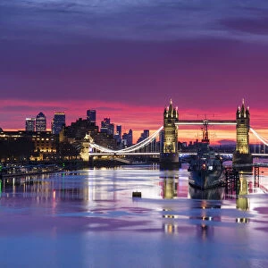 Tower Bridge and HMS Belfast reflecting in a still River Thames at sunset, London, England, United Kingdom, Europe