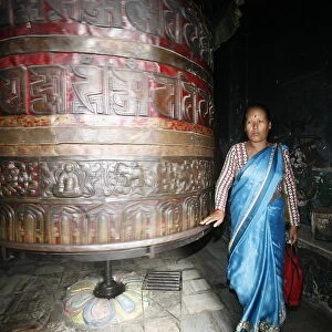 Woman and prayer wheel, Swayambhunath Temple, Kathmandu, Nepal, Asia