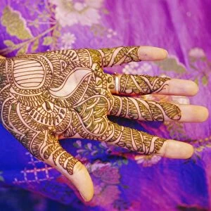 Womans hand decorated with henna