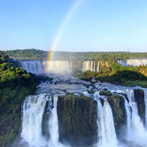 Brazil, Parana state, a rainbow photographed over the Iguacu or Iguazu falls as seen
