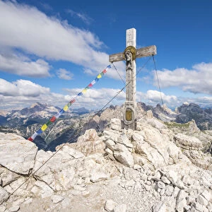 Wooden cross on top of Mount Paterno and surrounding landscape in summer. Sesto Dolomites