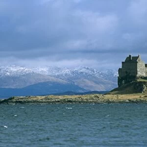 Duart Castle and the Lismore lighthouse. the castle has been the home of the Clan Maclean since the 14th century. Isle of Mull, Scotland