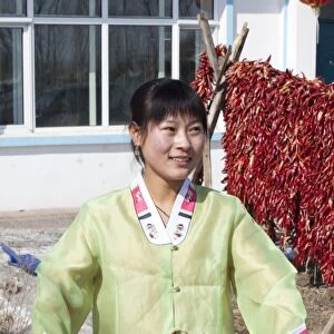 An ethnic South Korean woman farmer in Northern China shows off her chillies