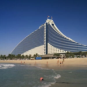 UAE, Dubai Jumeirah Beach Hotel with people on private beach in foreground