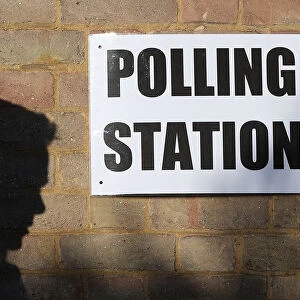 A man enters a polling station as voting begins in local government elections in London