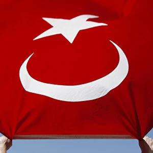 A man holds up a Turkish flag in Istanbul